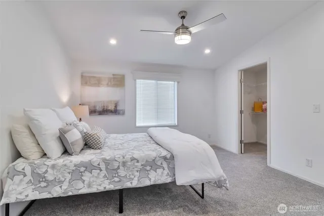 a bedroom with a large bed and a chandelier