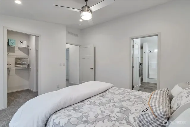 a bedroom with a large bed and a chandelier