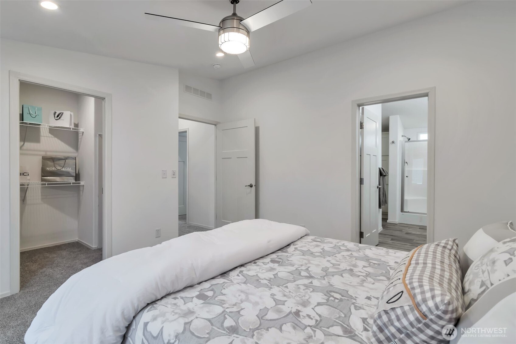 23708 Locust Way, Unit 65 Bothell, WA 98021 - Photo 16 of 32 a bedroom with a large bed and a chandelier