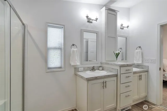 a bathroom with a granite countertop sink and a mirror