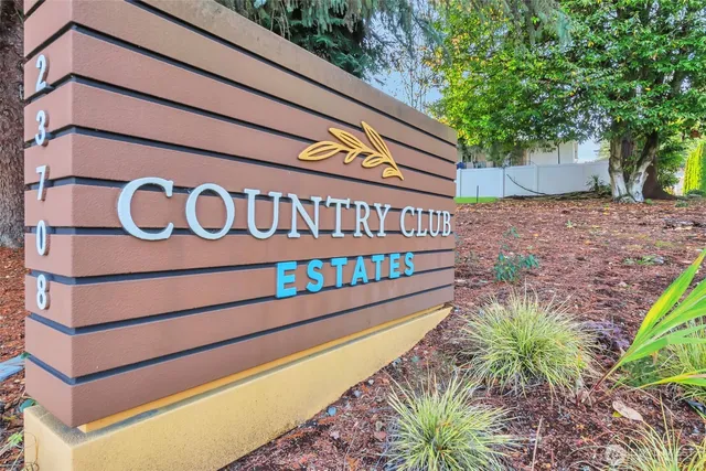 a view of a street with potted plants