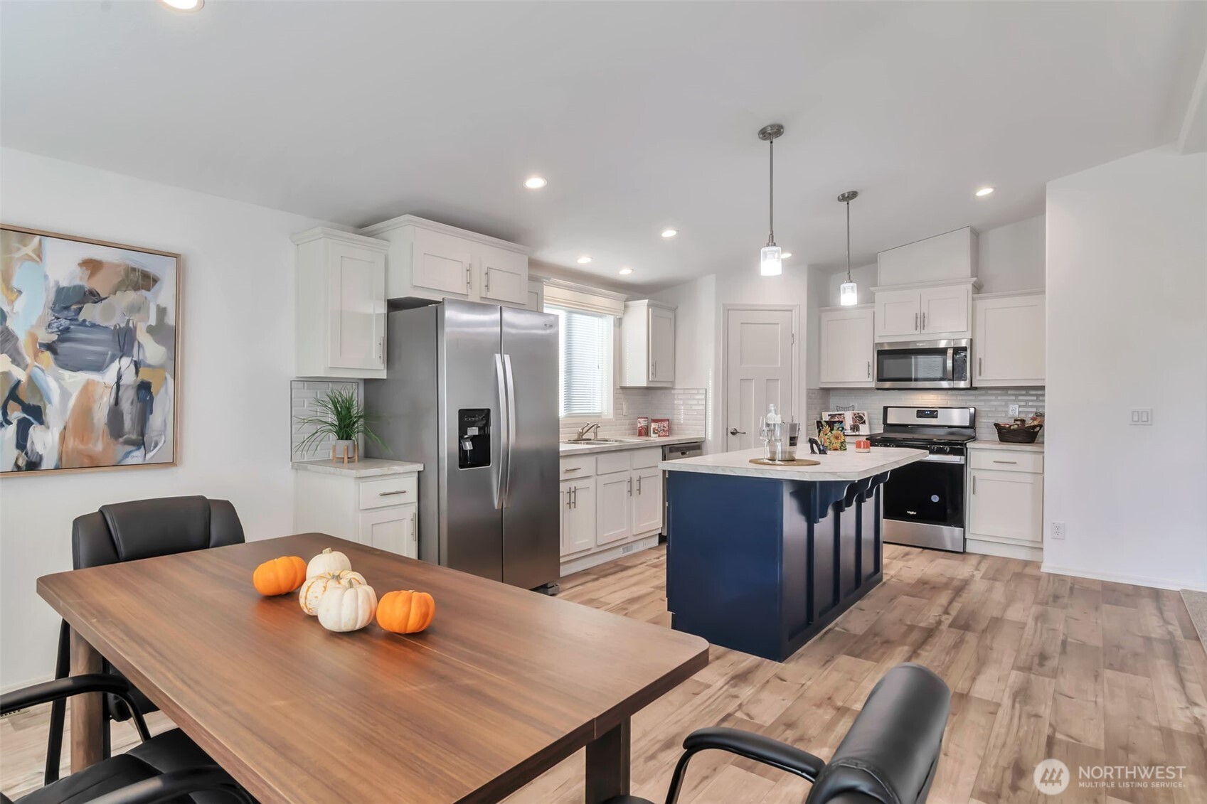 23708 Locust Way, Unit 65 Bothell, WA 98021 - Photo 5 of 32 a kitchen with a dining table cabinets and refrigerator