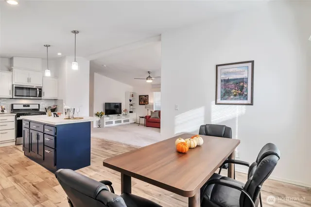 a large kitchen with a table and chairs