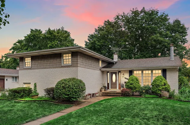 a view of a house with a yard and a garden