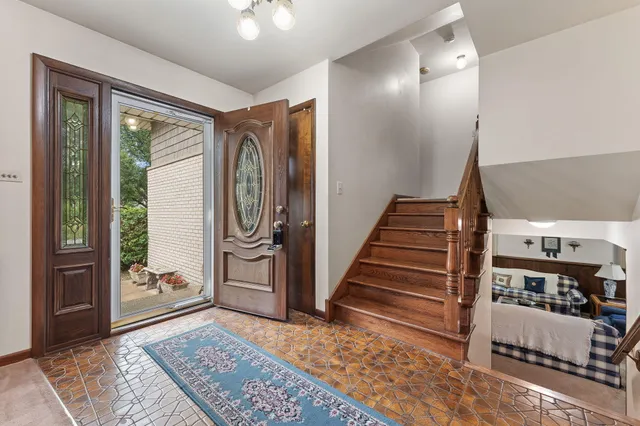 a view of entryway and hall with wooden floor