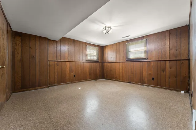 a spacious bedroom with a bed and window