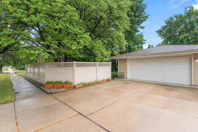 a front view of a house with a yard and trees