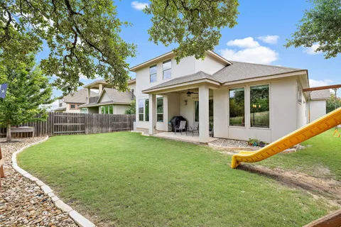 a view of a house with backyard porch and sitting area
