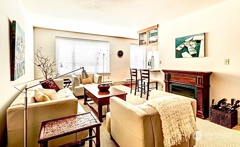 1105 Spring Street, Unit 203 Seattle, WA 98104 - Photo 3 of 21 a living room with furniture a rug and a large window