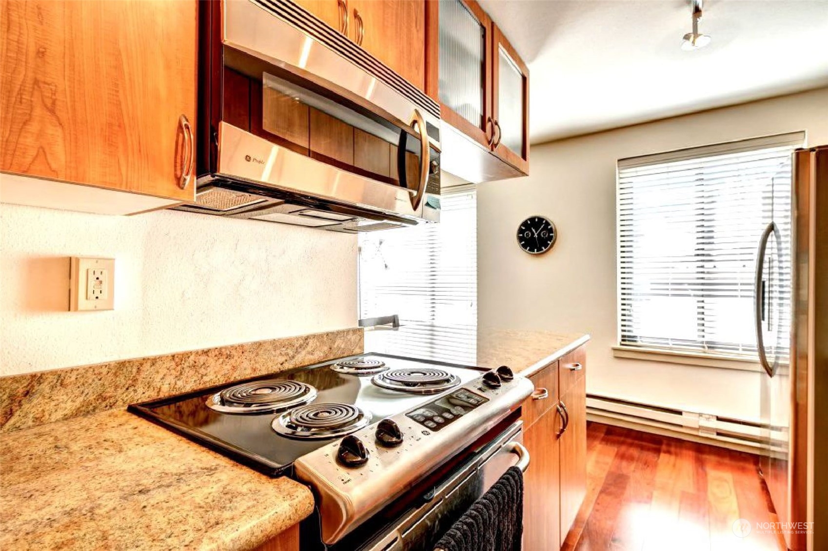 1105 Spring Street, Unit 203 Seattle, WA 98104 - Photo 7 of 21 a kitchen with a stove a sink and a window
