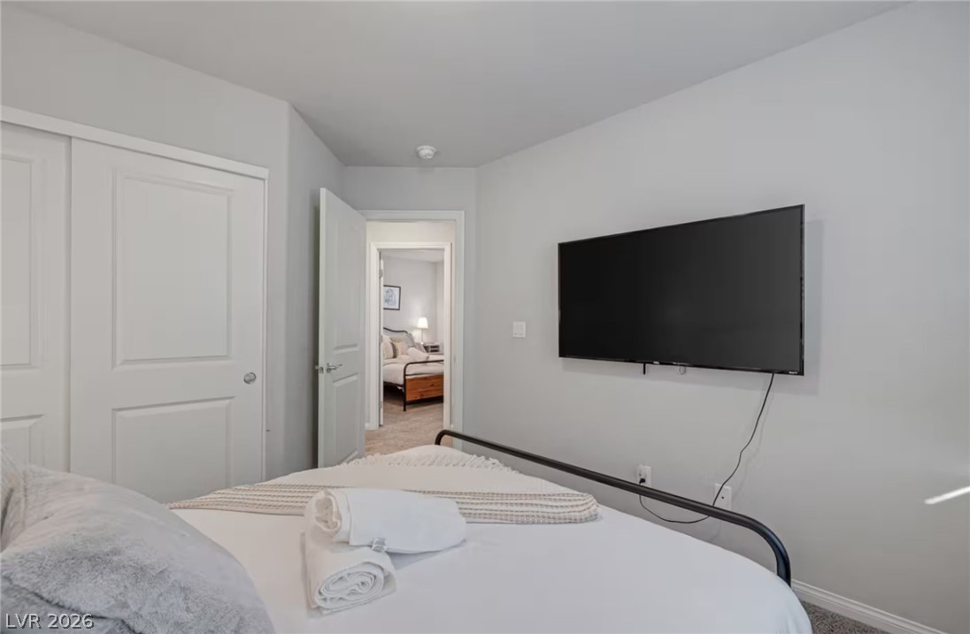 8244 Selenite Street Las Vegas, NV 89113 - Photo 11 of 16 This cozy bedroom features a neutral palette and ample natural light, ideal for peaceful slumber.