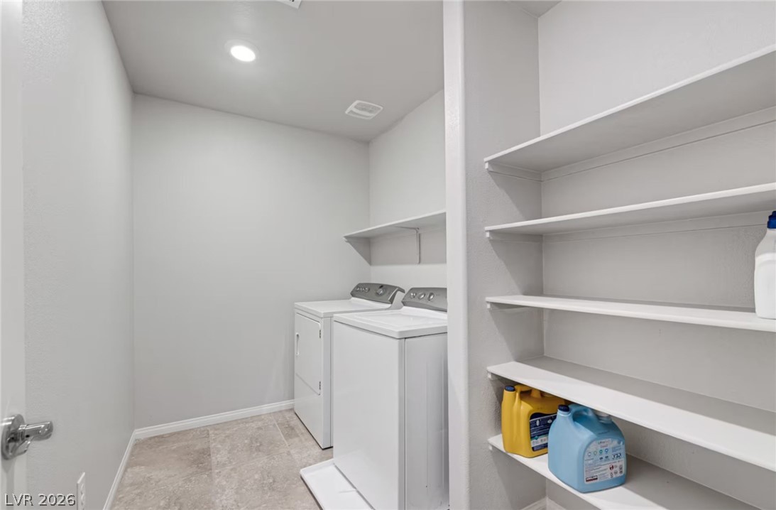 8244 Selenite Street Las Vegas, NV 89113 - Photo 16 of 16 This dedicated laundry area offers convenient functionality and ample storage solutions.