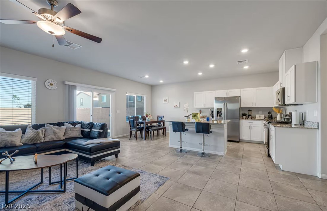 8244 Selenite Street Las Vegas, NV 89113 - Photo 5 of 16 An inviting open concept living space features a functional kitchen and a comfortable area for gathering.