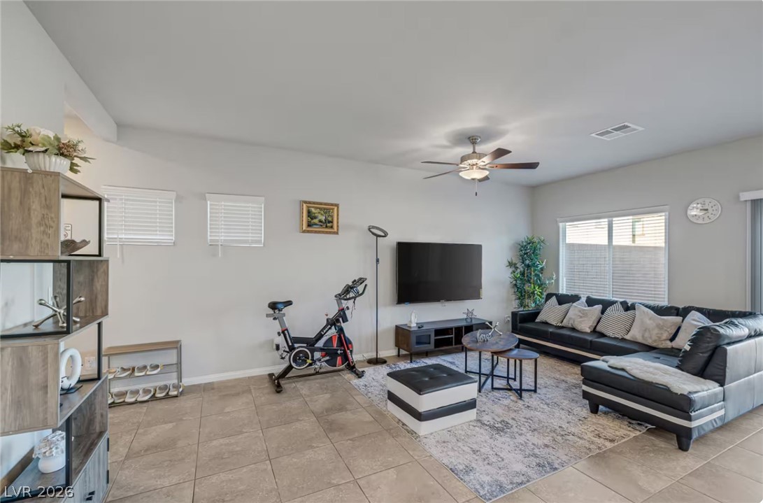 8244 Selenite Street Las Vegas, NV 89113 - Photo 6 of 16 This living room features comfortable seating and an open, airy atmosphere.
