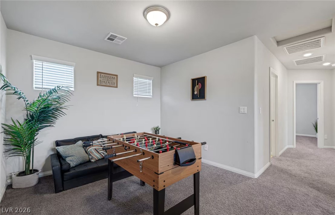 8244 Selenite Street Las Vegas, NV 89113 - Photo 7 of 16 This versatile recreation room features abundant natural light, offering a vibrant space for leisure and entertainment.
