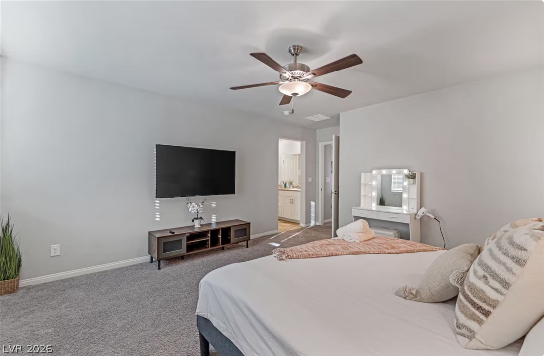 8244 Selenite Street Las Vegas, NV 89113 - Photo 9 of 16 This inviting bedroom features soft carpeting and a ceiling fan, offering comfort and relaxation.