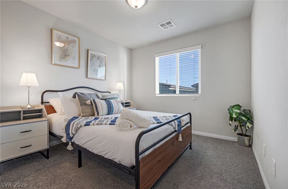 8244 Selenite Street Las Vegas, NV 89113 - Photo 10 of 16 This inviting bedroom provides a comfortable and peaceful retreat.