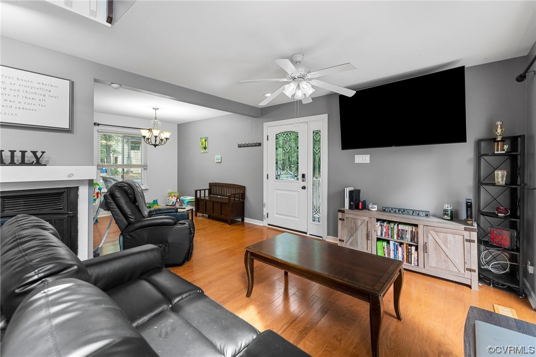 10706 Genlou Road Chesterfield, VA 23832 - Photo 9 of 34 a living room with furniture a flat screen tv and kitchen view
