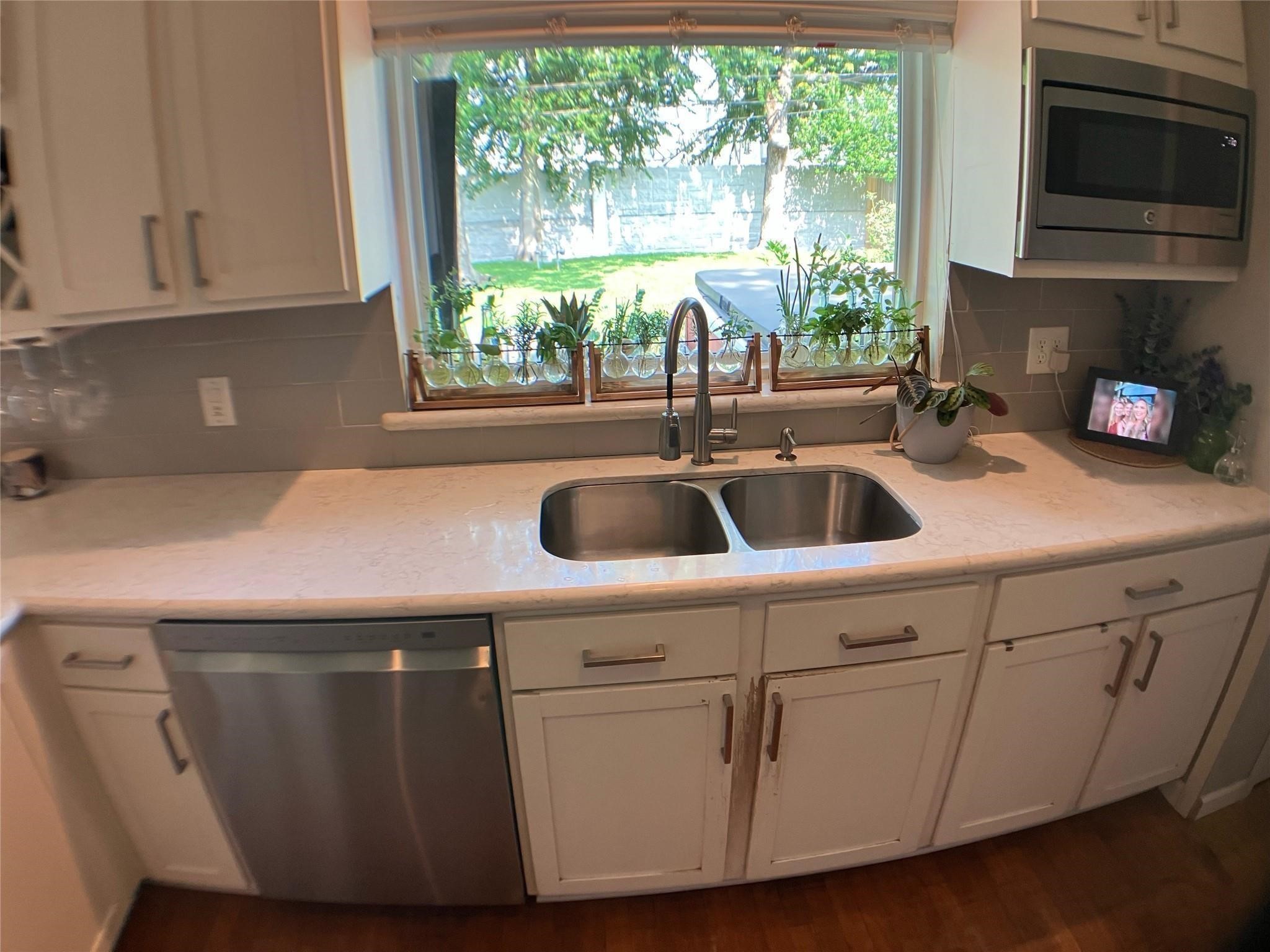 3027 Guese Road Houston, TX 77018 - Photo 5 of 22 Kitchen overlooks the backyard through a large window while offering generous counter and cabinet space.