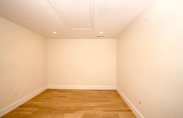 a view of a room with wooden floor