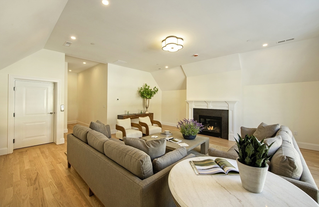 25 Clubview Drive, Unit 25 Andover, MA 01810 - Photo 14 of 19 a living room with furniture potted plant and a fireplace