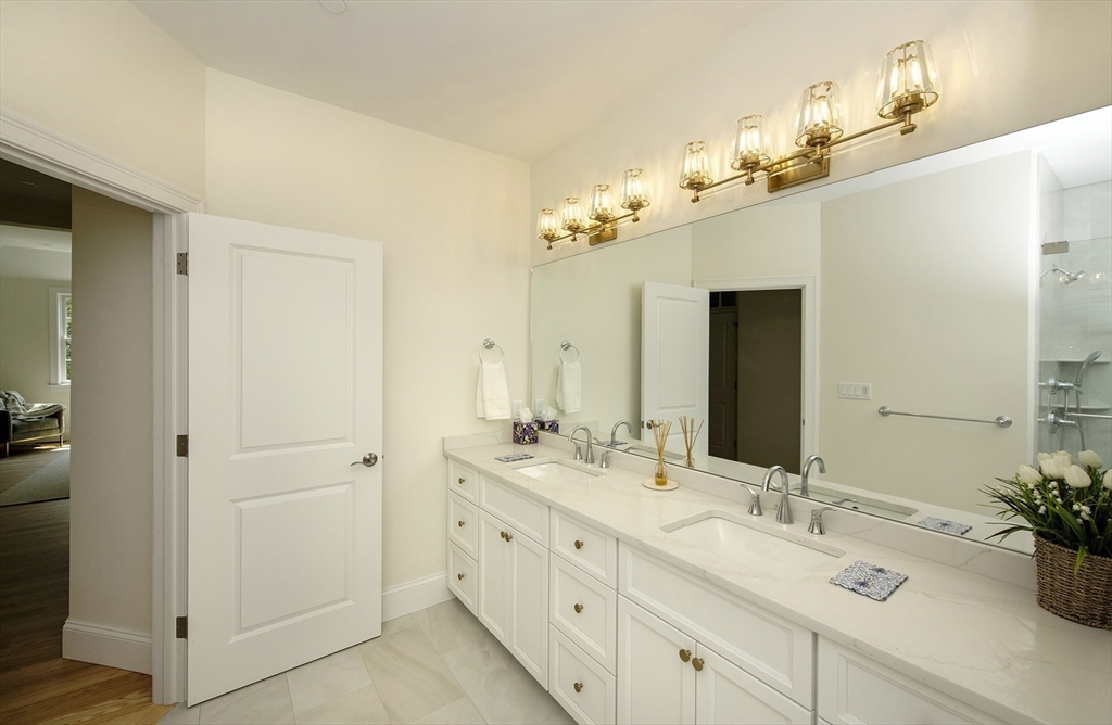 25 Clubview Drive, Unit 25 Andover, MA 01810 - Photo 16 of 19 a bathroom with a double vanity sink and a mirror