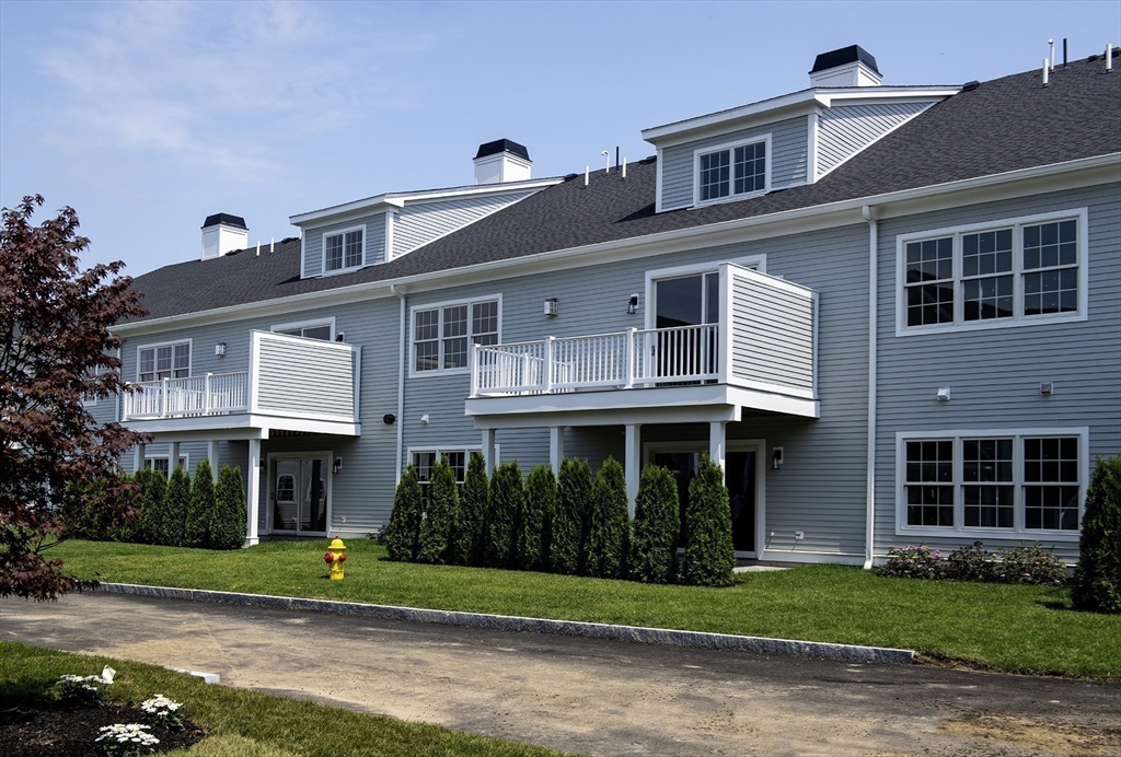 25 Clubview Drive, Unit 25 Andover, MA 01810 - Photo 17 of 19 a front view of a house with a yard