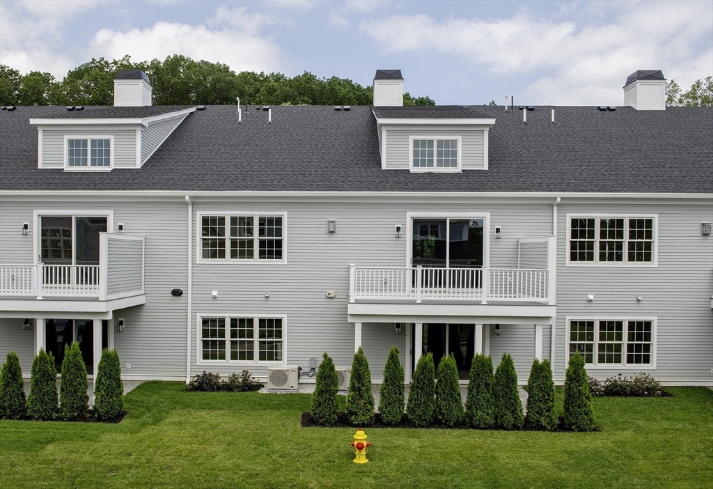 25 Clubview Drive, Unit 25 Andover, MA 01810 - Photo 18 of 19 a front view of a house with garden and porch