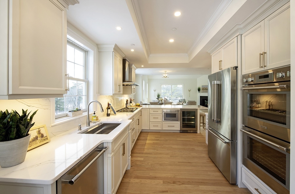 25 Clubview Drive, Unit 25 Andover, MA 01810 - Photo 3 of 19 a kitchen with a sink a counter top space stainless steel appliances and windows