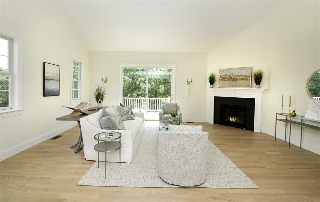 25 Clubview Drive, Unit 25 Andover, MA 01810 - Photo 6 of 19 a living room with furniture a large window and a fireplace