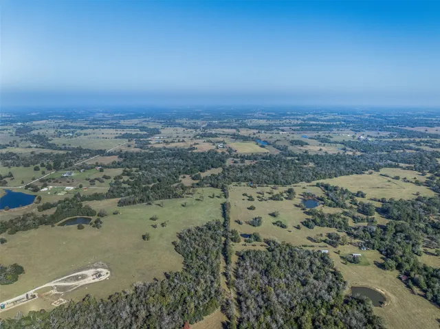 an aerial view of a houses with a lake view