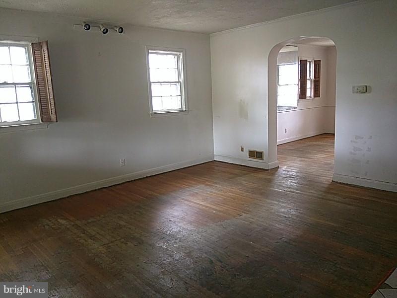 4028 Fallstaff Road Baltimore, MD 21215 - Photo 3 of 28 a view of an empty room with wooden floor and a window