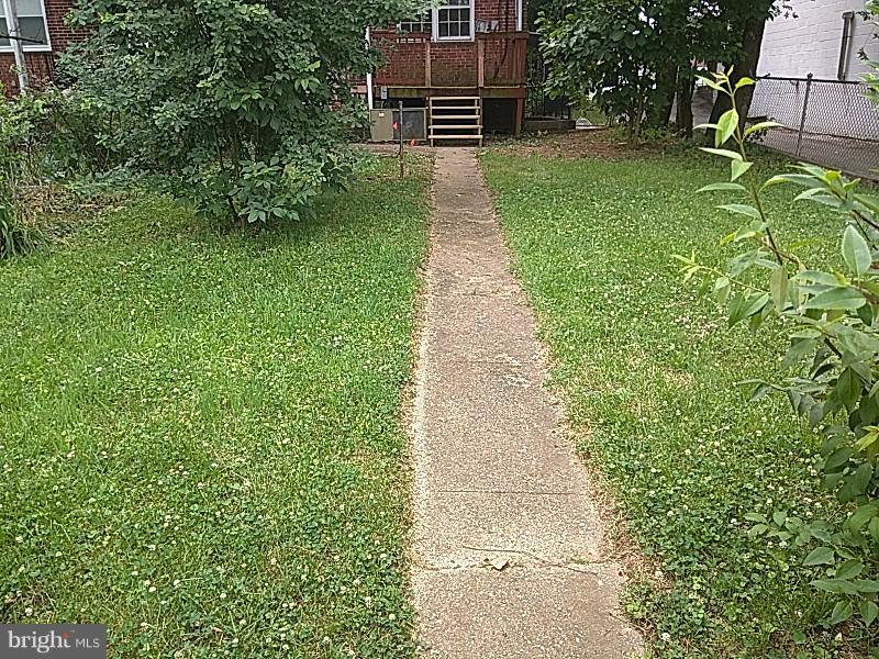 4028 Fallstaff Road Baltimore, MD 21215 - Photo 26 of 28 a view of a backyard with potted plants and large trees