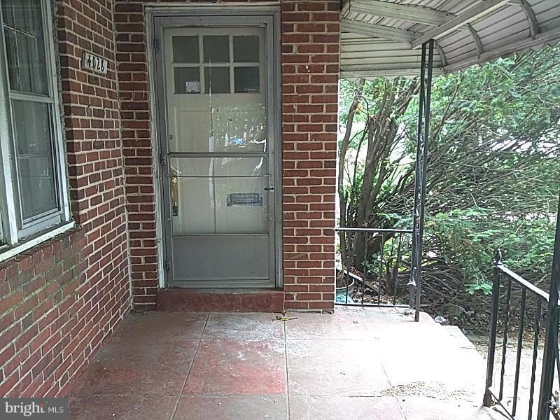 4028 Fallstaff Road Baltimore, MD 21215 - Photo 27 of 28 a view of door and wooden house