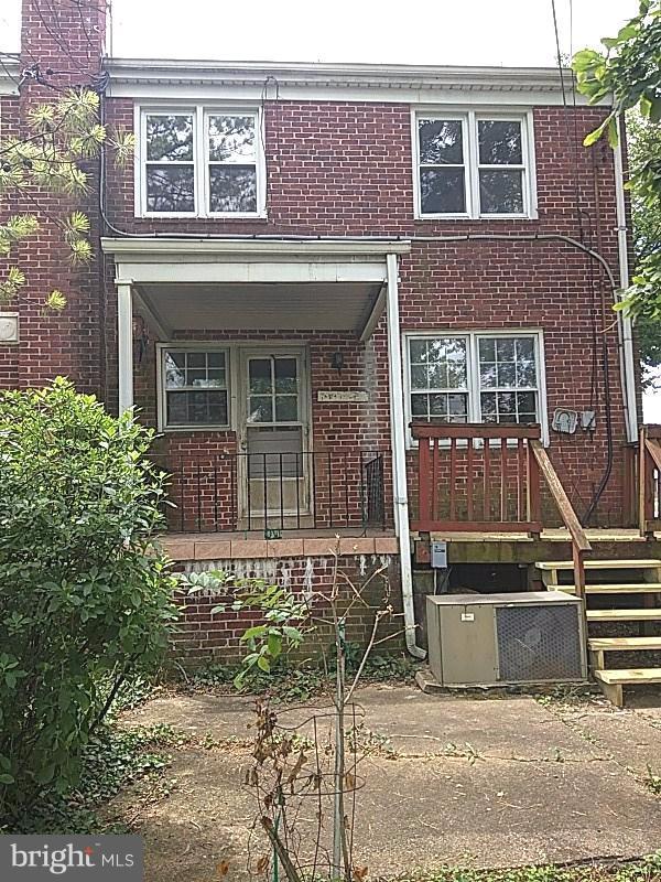 4028 Fallstaff Road Baltimore, MD 21215 - Photo 28 of 28 front view of a brick house with a small yard