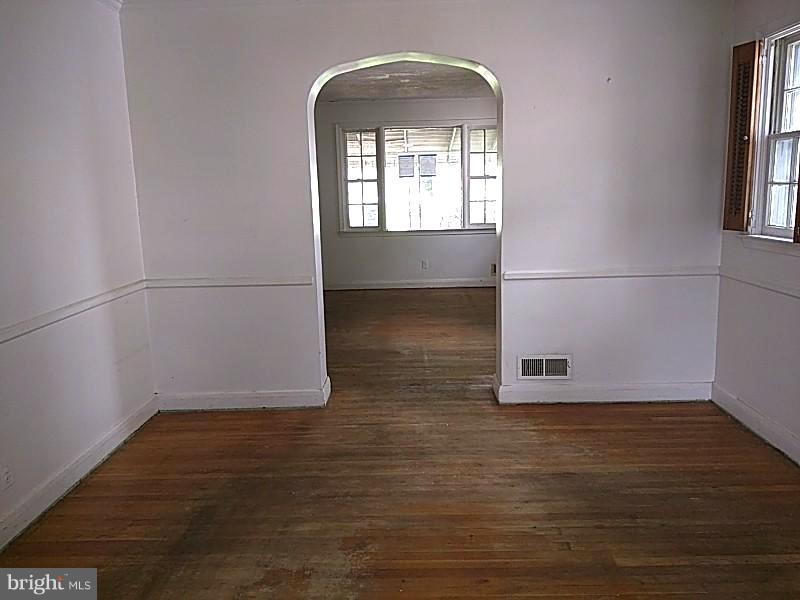 4028 Fallstaff Road Baltimore, MD 21215 - Photo 6 of 28 an empty room with wooden floor and windows