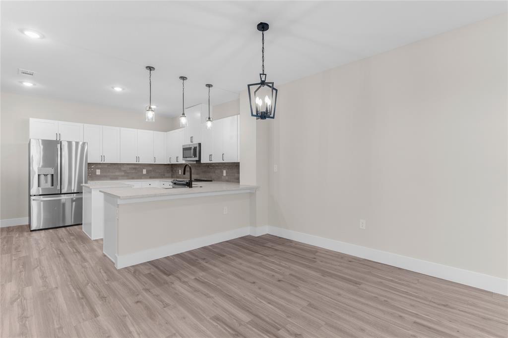 1650 Palladio Loop, Unit 2 Princeton, TX 75407 - Photo 9 of 14 Open concept living space featuring wood-finish flooring