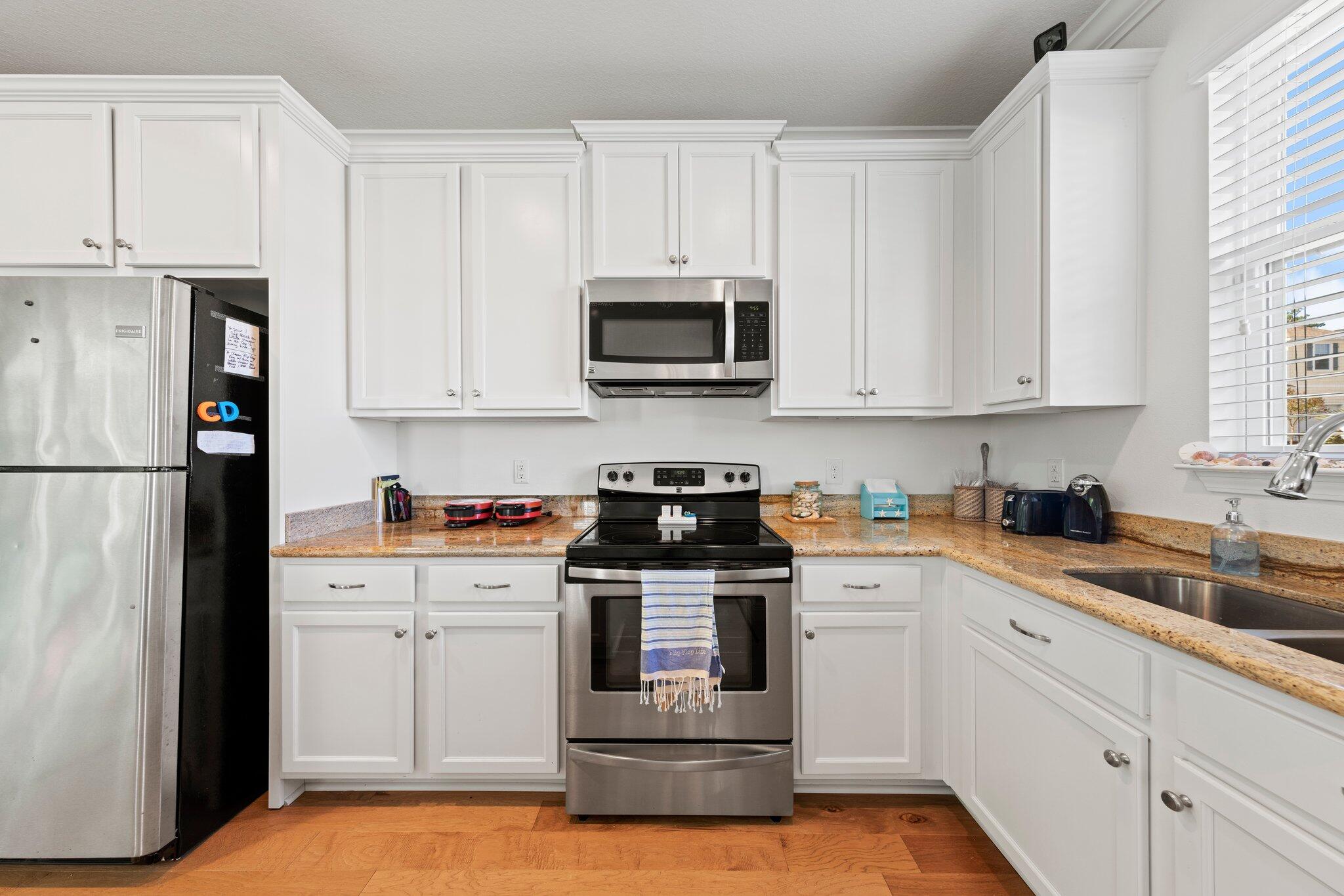174 Sandpine Loop Inlet Beach, FL 32461 - Photo 15 of 45 a kitchen with granite countertop white cabinets and stainless steel appliances