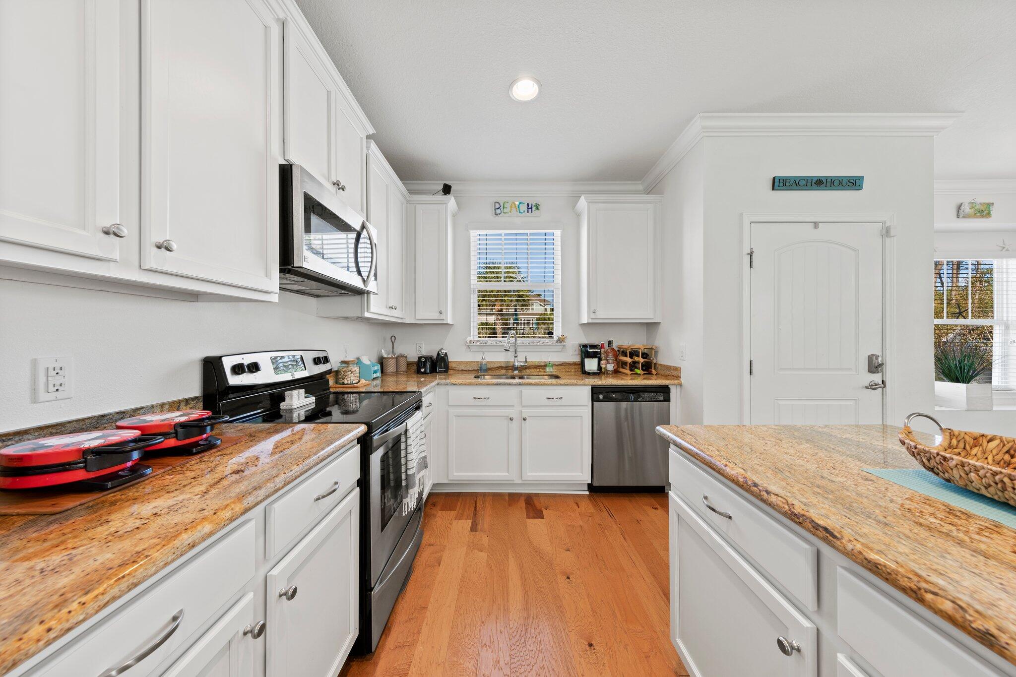 174 Sandpine Loop Inlet Beach, FL 32461 - Photo 16 of 45 a kitchen with granite countertop stainless steel appliances stove top oven and cabinets