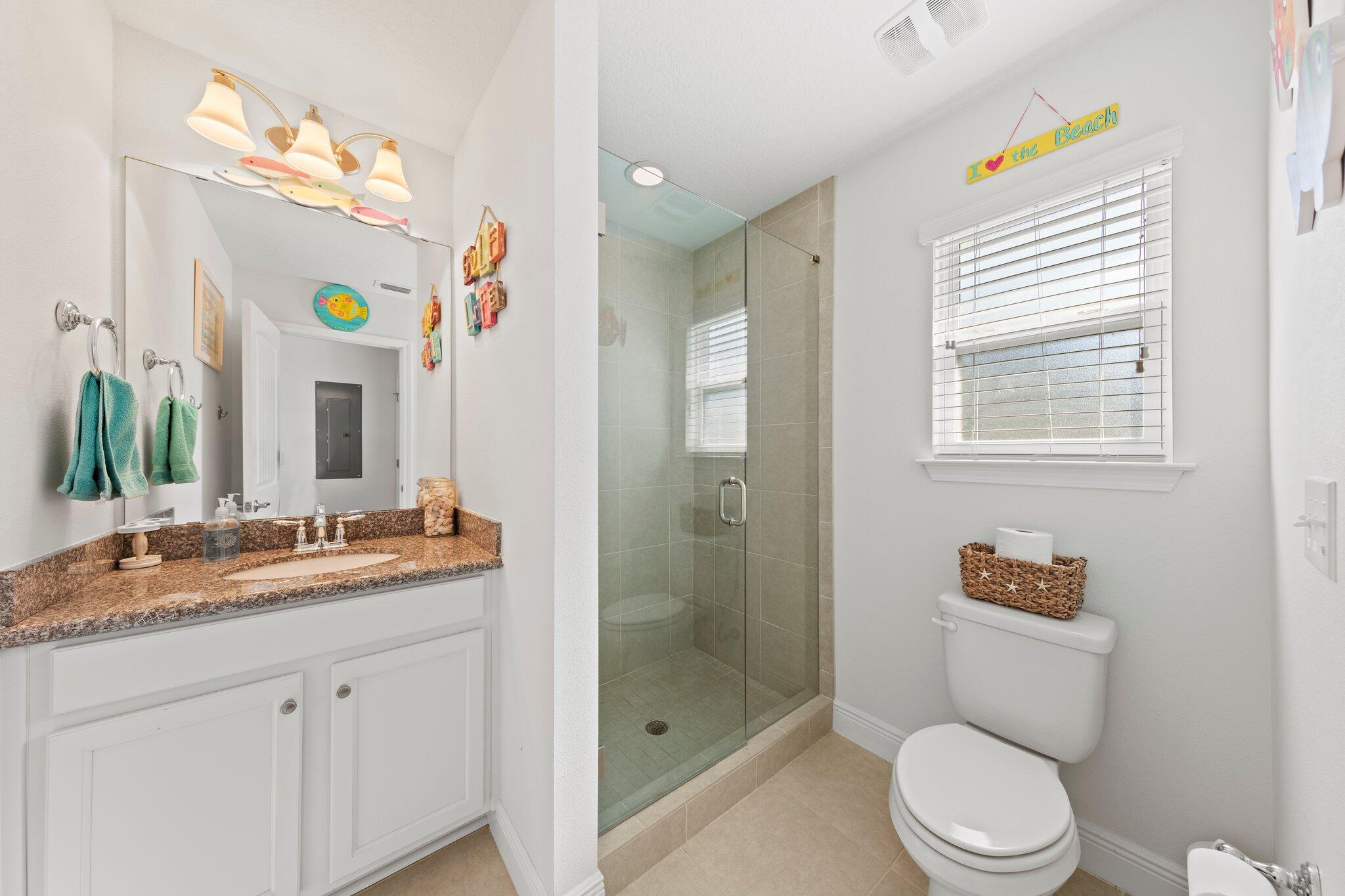 174 Sandpine Loop Inlet Beach, FL 32461 - Photo 30 of 45 a bathroom with a granite countertop toilet sink and mirror