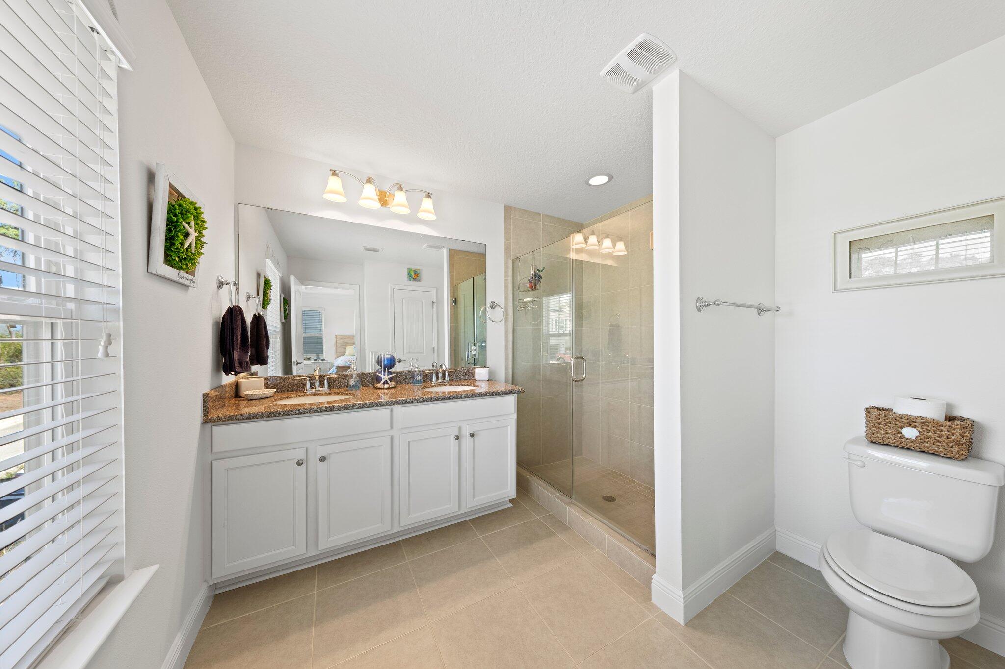 174 Sandpine Loop Inlet Beach, FL 32461 - Photo 40 of 45 a bathroom with a double vanity sink toilet and shower