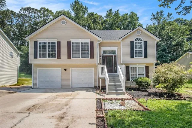 a front view of a house with a yard and garage