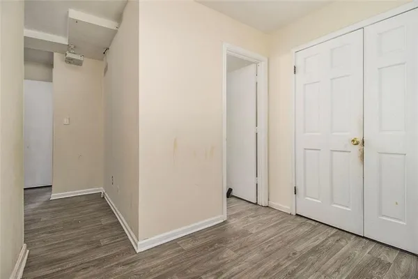 a view of a room with wooden floor