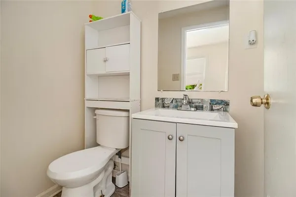 a bathroom with a sink a toilet and vanity