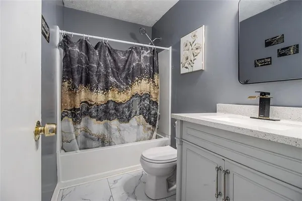 a bathroom with a shower a toilet and a sink