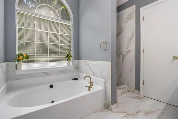 a bathroom with a tub and a shower