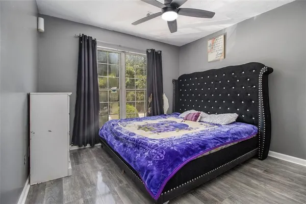 a large bed sitting in a bedroom next to a window