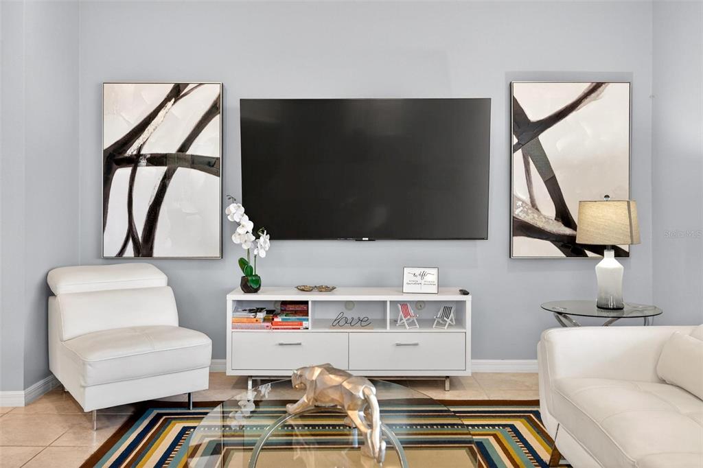 7554 Oak Spring Lane Davenport, FL 33837 - Photo 12 of 74 a living room with a couch and a flat screen tv