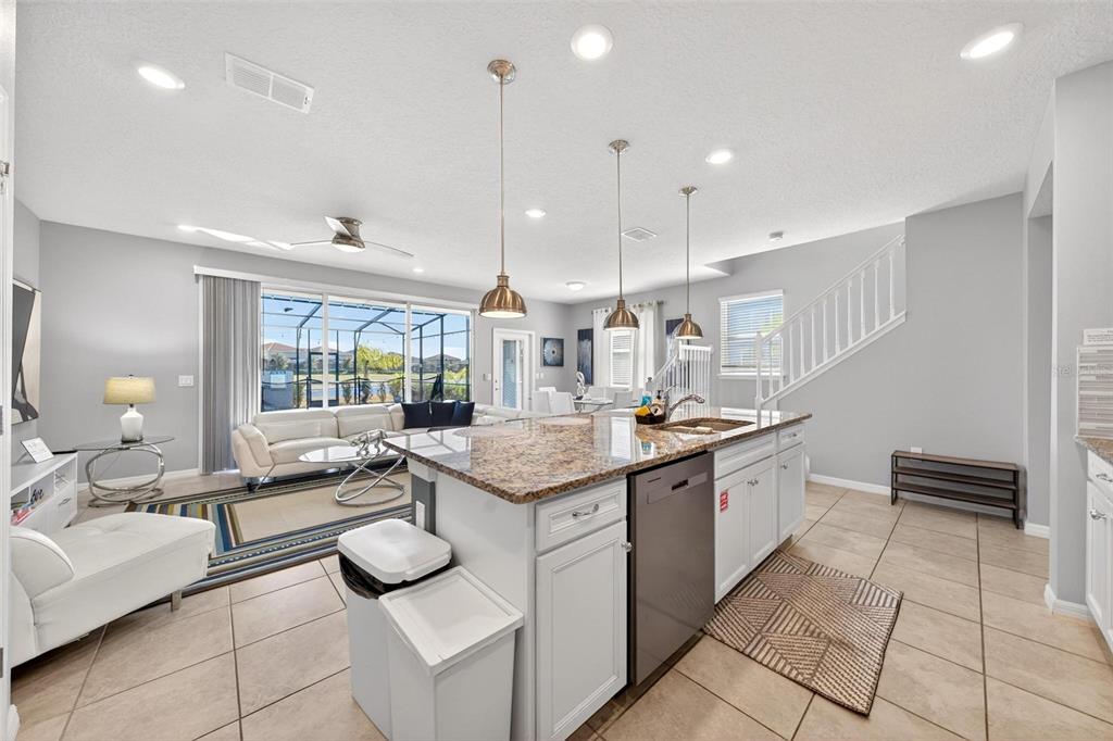 7554 Oak Spring Lane Davenport, FL 33837 - Photo 21 of 74 a kitchen with stainless steel appliances kitchen island granite countertop a sink and cabinets