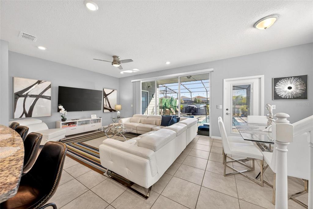 7554 Oak Spring Lane Davenport, FL 33837 - Photo 23 of 74 a living room with furniture and a flat screen tv